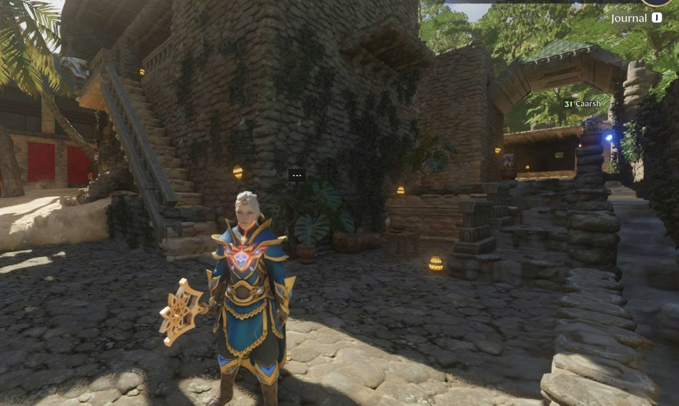 Player character in blue and gold armor standing inside a stone-built base in Enshrouded